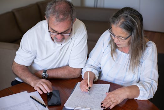 retired couple discussing finances at a kitchen table