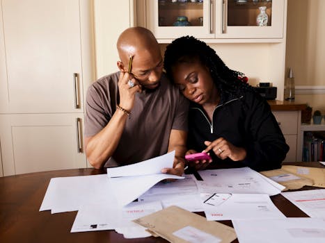 retired couple relaxing at home with financial documents