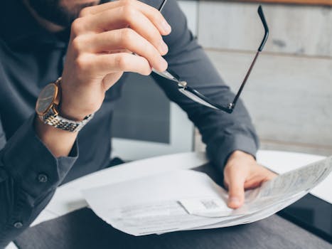 retiree smiling while reviewing financial documents