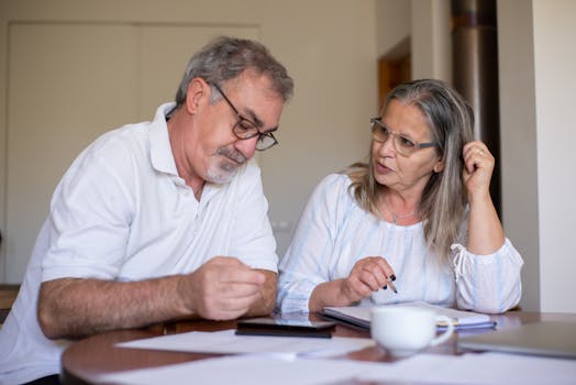 Retired couple discussing finances at home