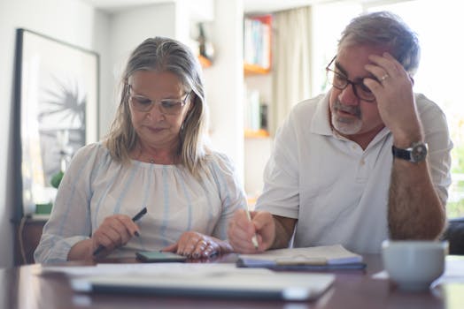 Retired couple discussing finances at home