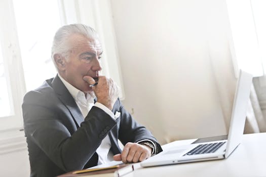 senior man calculating finances on a laptop