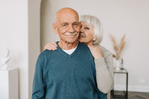 retired couple smiling while reviewing finances