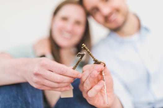 happy retired couple holding keys to their new home