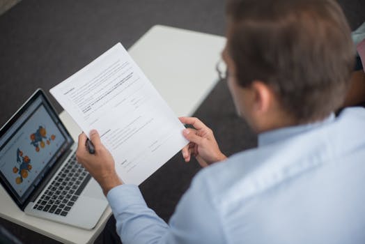 older man reviewing property portfolio on laptop