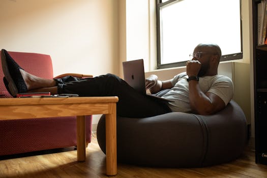 man looking stressed while working on a laptop