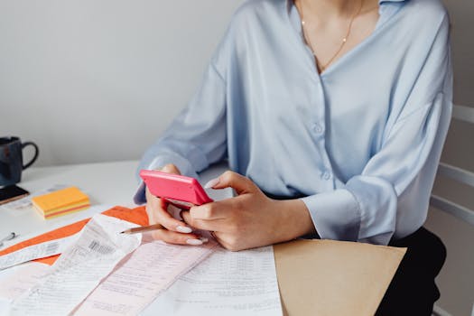 person organizing financial documents on a desk