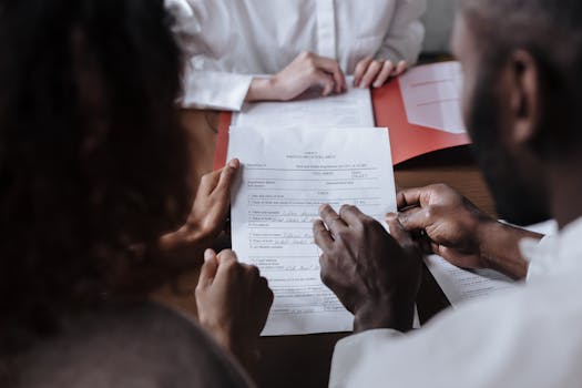 person signing mortgage documents at a table