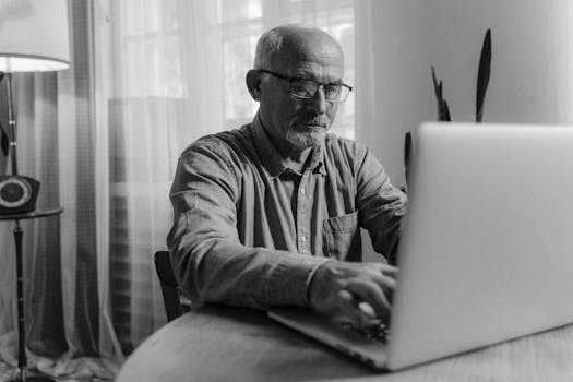 retiree working on laptop at home