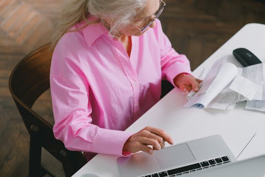 senior couple smiling while reviewing financial documents