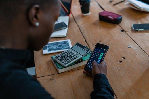 older adult using a calculator to review finances