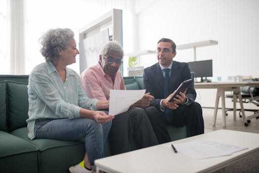 financial advisor meeting with elderly client