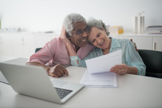 elderly couple reviewing documents at home