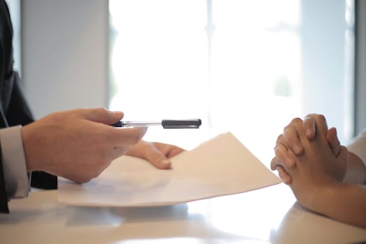 retiree signing documents with a mortgage loan originator