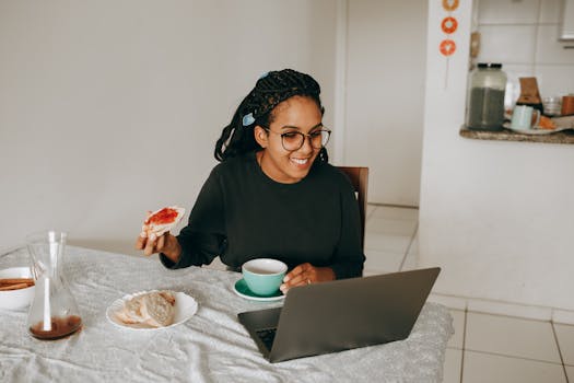 happy retiree working on a laptop with a cup of coffee