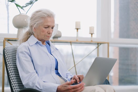 retired person working on a laptop at home