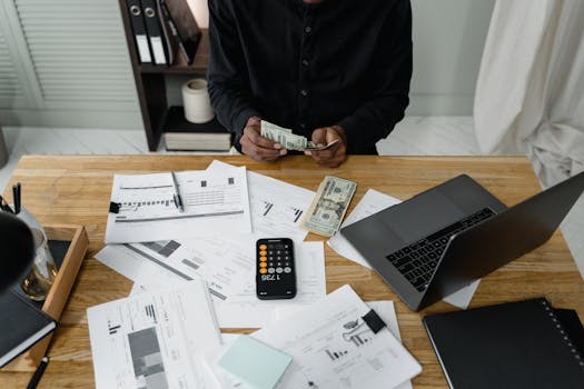 retired man calculating expenses on a laptop