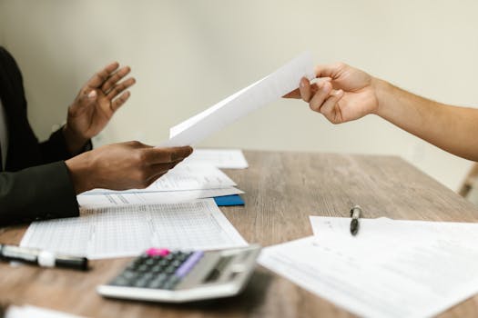 calculator and paperwork on a table