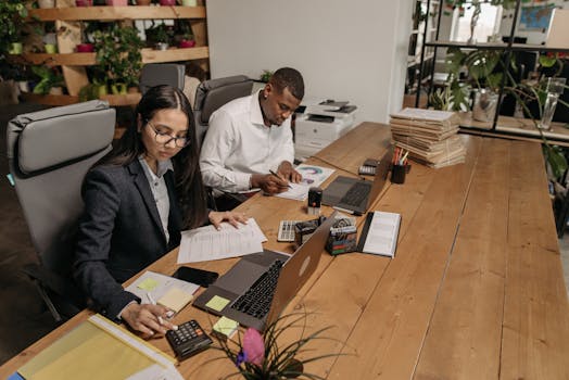 man using calculator to plan finances