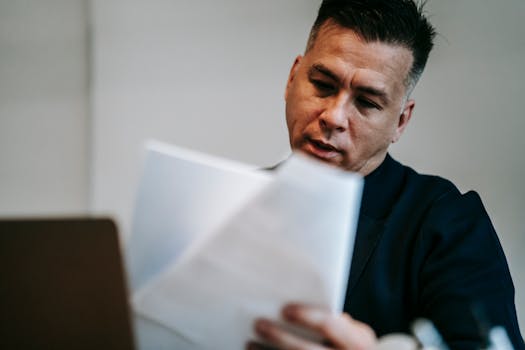 person reviewing mortgage documents at a desk