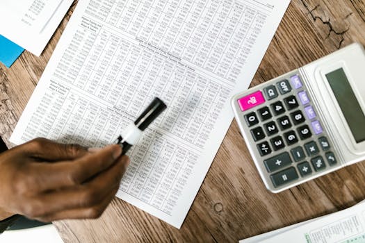 financial calculator and pen on table