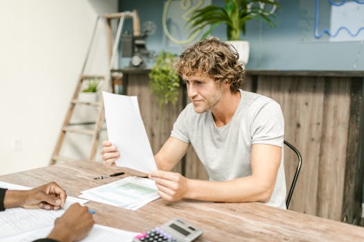 person reviewing documents on a desk