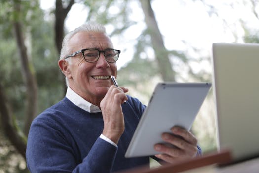 elderly man using a tablet to research financial options