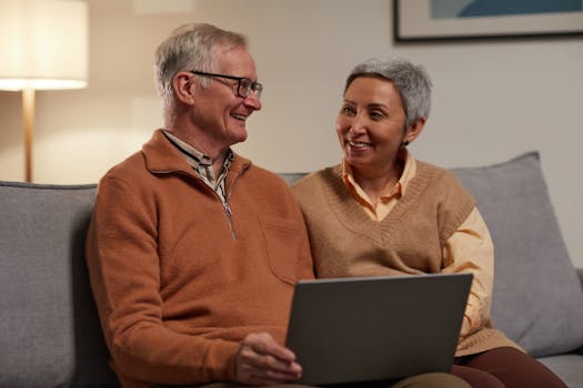 elderly couple smiling in their living room