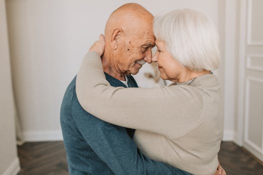 retired couple smiling while reviewing finances