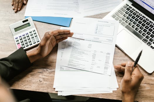 stack of tax documents with a pen